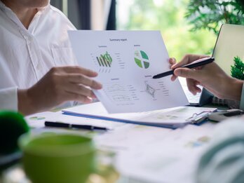 Reviewing,Sustainability,Reports,And,Environmental,Performance,Charts,In,Business,Meeting.
