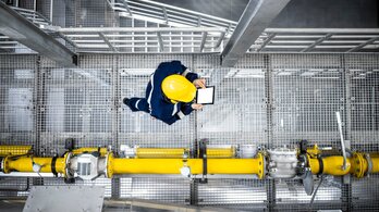 Top,View,Of,Petroleum,Refinery,Worker,Walking,By,Gas,Pipes